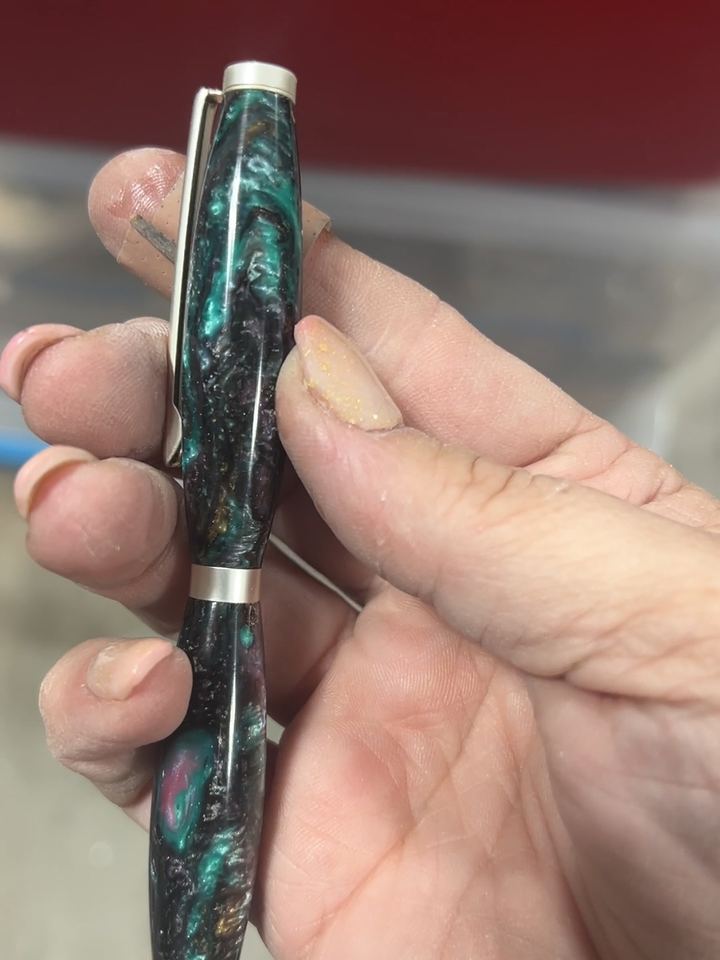 Pen with dark green, black, and pink galaxy style resin and satin silver hardware