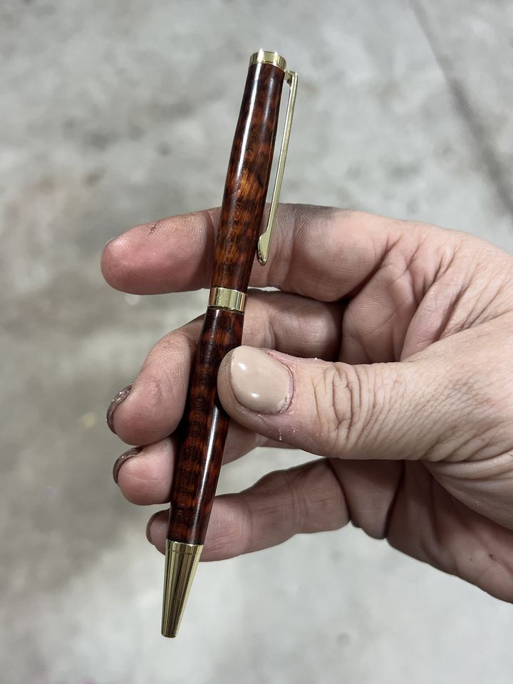 Dark reddish brown patterned wood pen with gold hardware